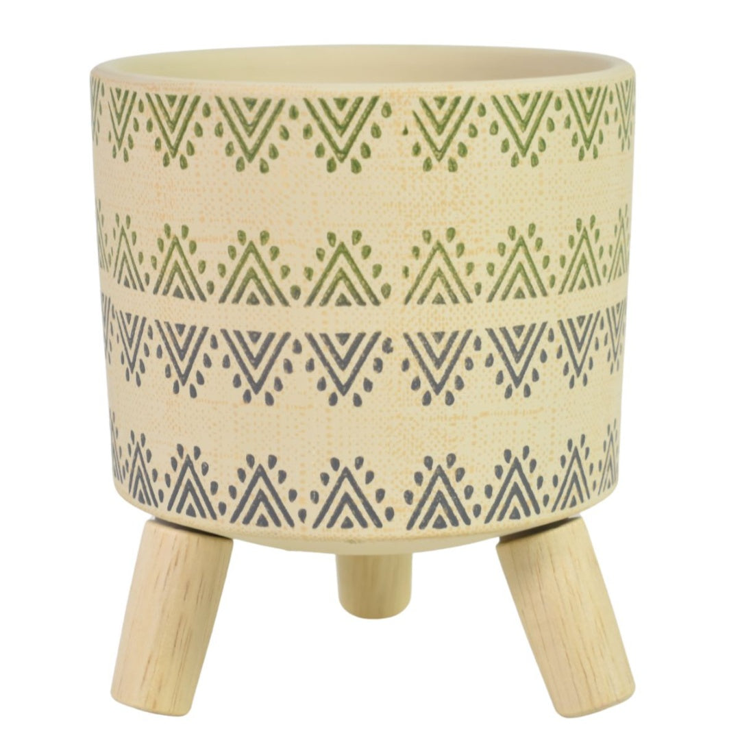 Maceta de cerámica con patas de madera. Beige